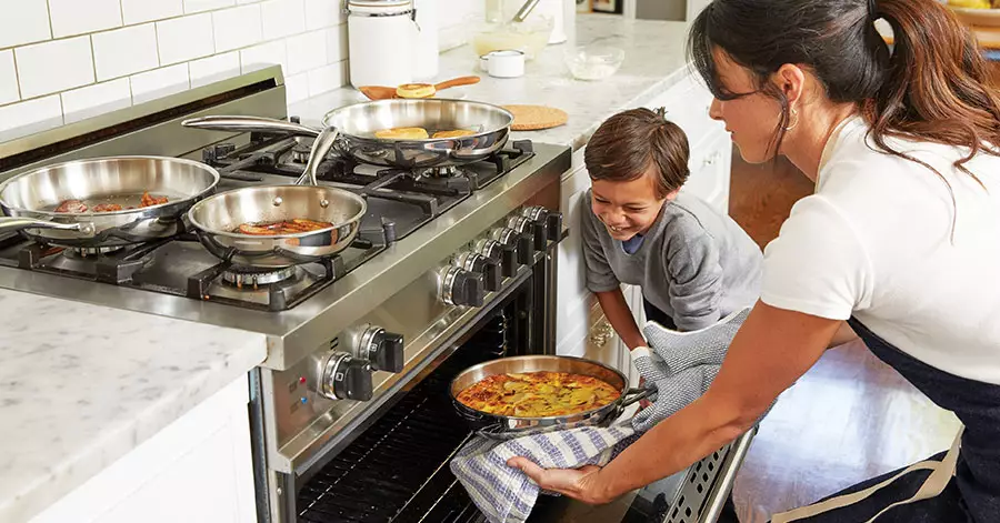 mother-son-putting-food-oven