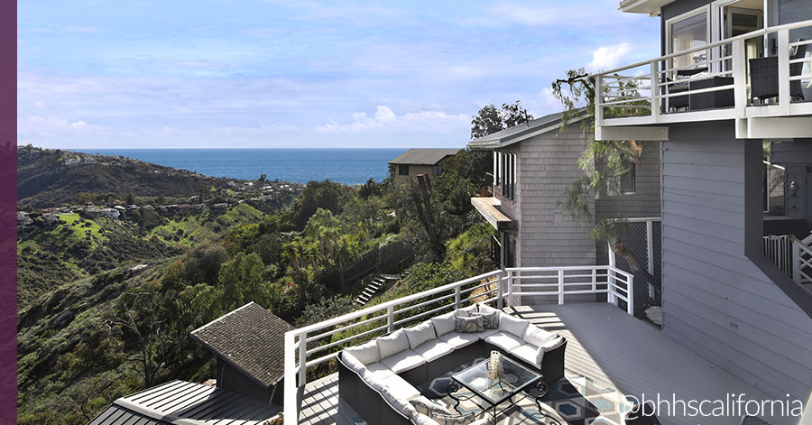 view from hilltop home overlooking ocean and green hillside