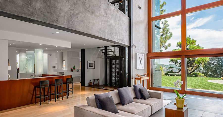 interior shot from living room looking out wall of glass windows