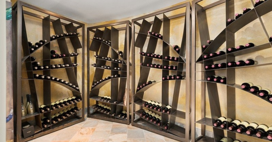 Unique, sculptural shelves holding wine bottles stacked on their sides