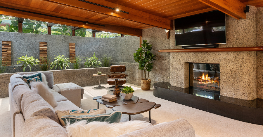 living room with walls of glass showcasing plants and nature outside