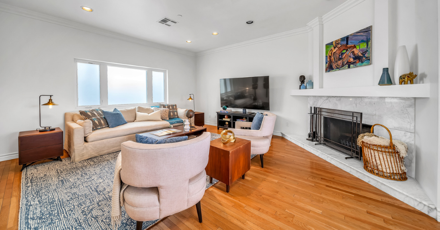 Modern living room and white marble fireplace in the corner