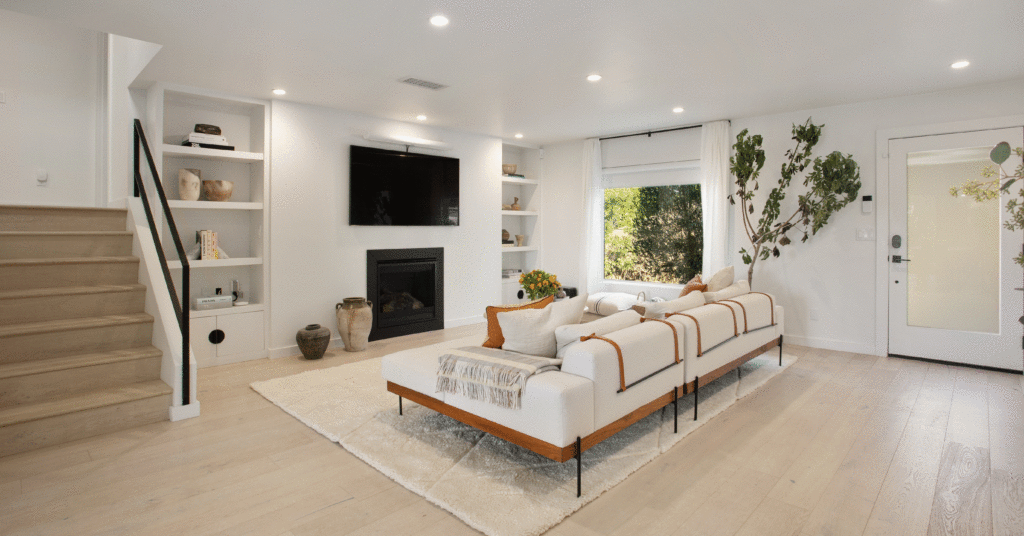 White modern living room with staircase leading to second floor 