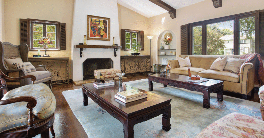 Earth-toned living room with large white fireplace. 