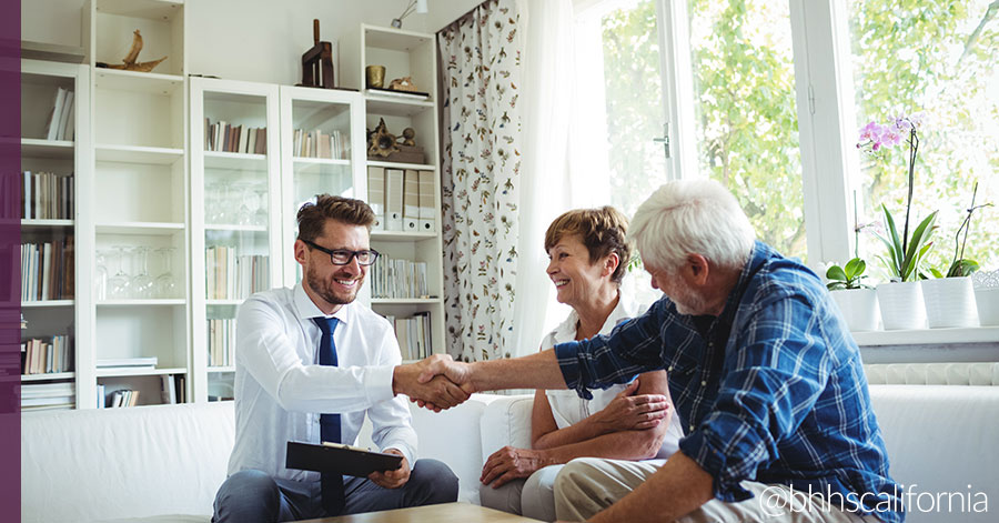 young realtor with clients showing how to be a successful real estate agent