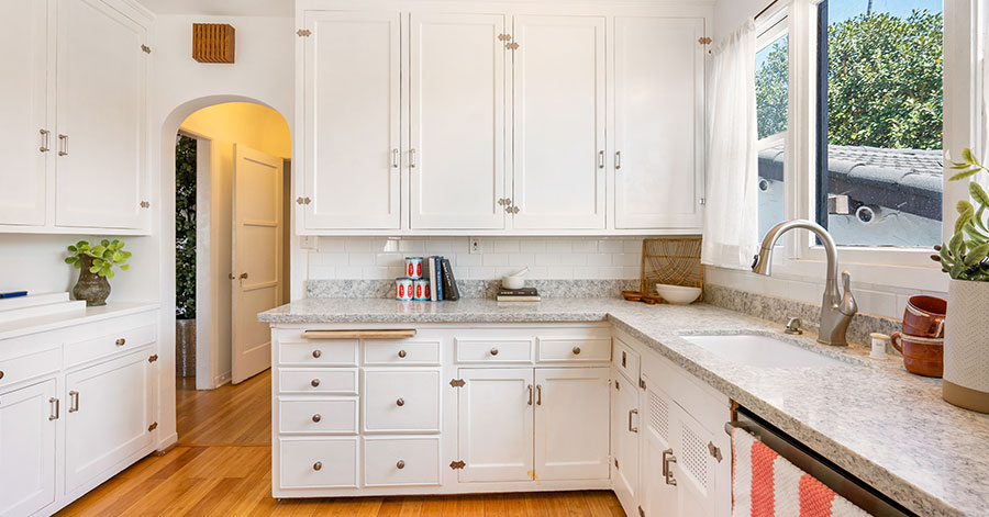 Light and bright kitchen with white cabinets and light grey countertops 