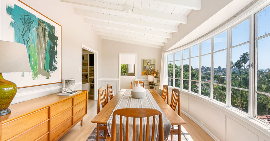 Long dining table and wall of glass windows looking out over Loz Feliz