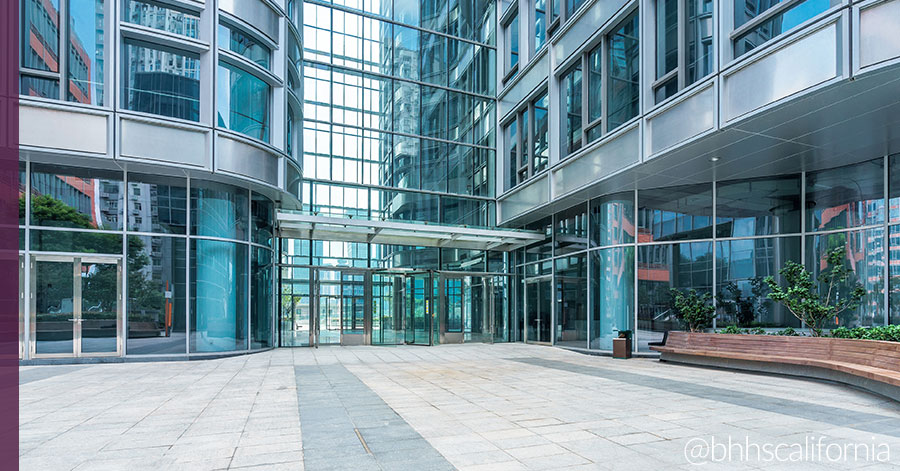 Exterior shot of office building to show why you should invest in commercial real estate 