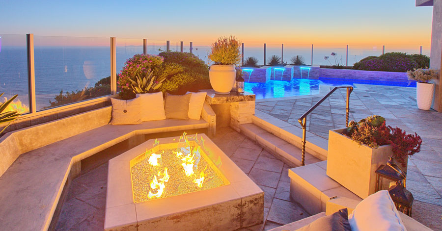 Beautiful Laguna Niguel back patio with fire pit, pool, waterfall, and ocean view.