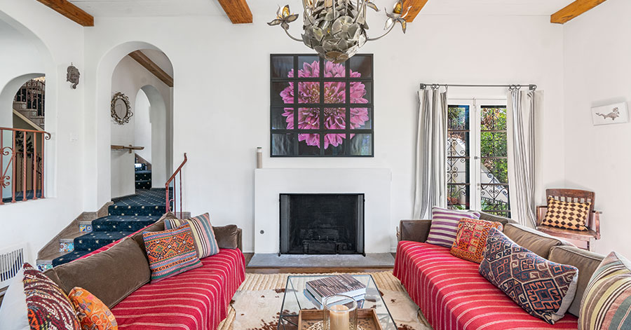 Interior shot of Spanish-style living room with high, beamed ceilings and lots of natural light