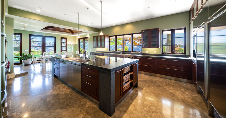 Luxury kitchen with dark wood cabinets and black countertops 