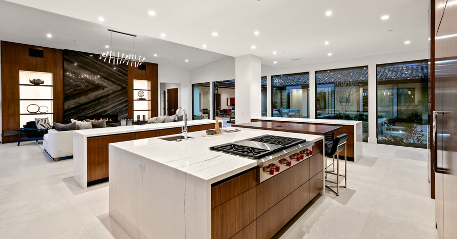 Spacious chef's kitchen with large center island and two smaller kitchen islands 