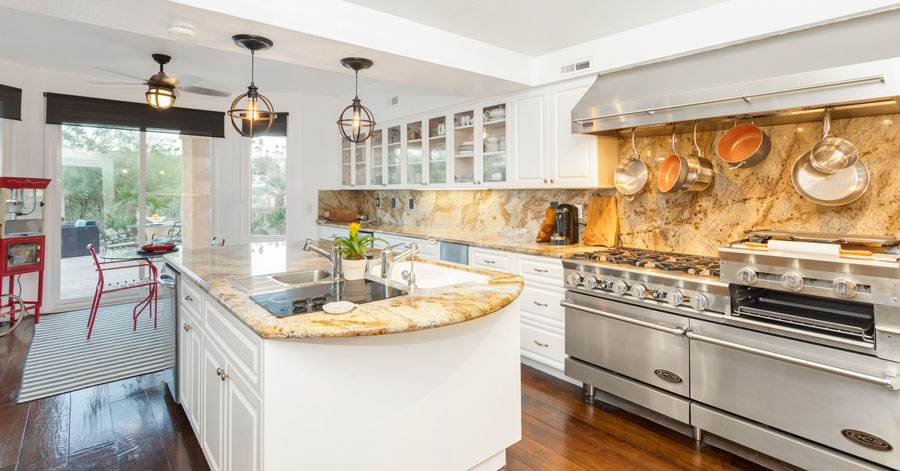 kitchen with white cabinets, stone counter tops, and stainless steel appliances