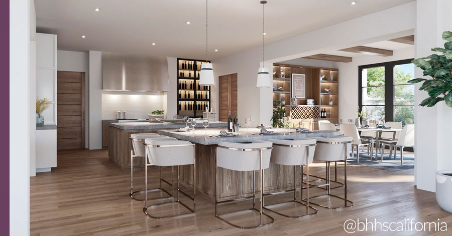 Luxury chef's kitchen with island and upholstered white barstool chairs