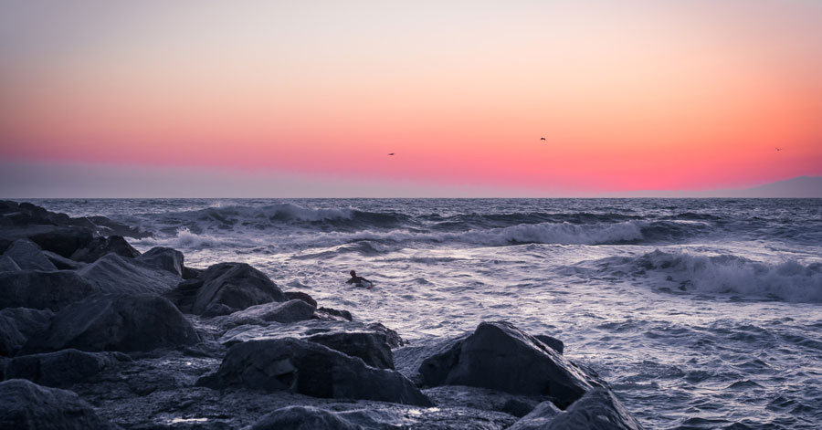 Swimmer in ocean at sunset at Surfer's Point at Seaside Park 