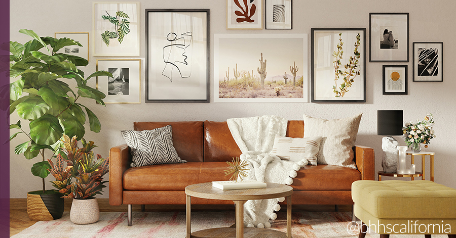 Home living room that includes elements of hygge such as a rug, throw pillows and blankets,  and warm tones. 