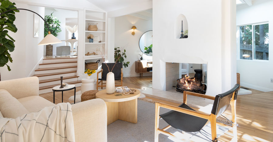 Light filled room with a large white fireplace 