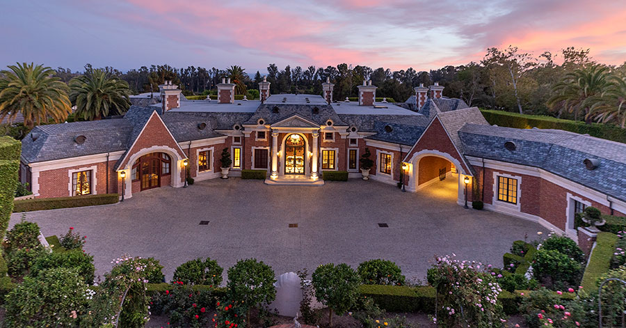 Aerial view of Montecito chateau's exterior and large front stone driveway