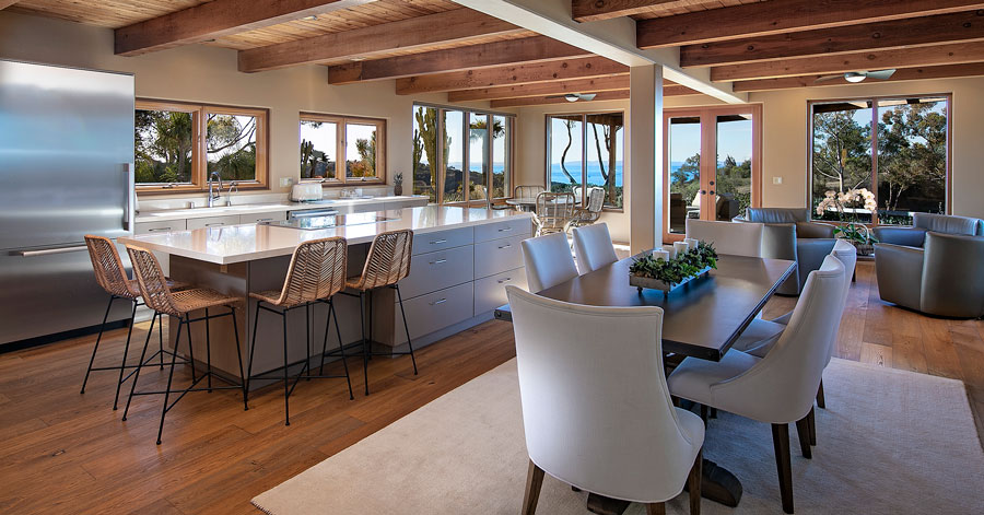 Wood beamed ceiling and stainless steel appliances with large kitchen island 