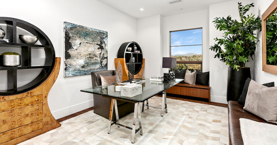 modern home office with bright natural light and views of hills outside 