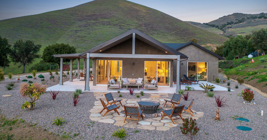 newly built homes backyard with firepit and mountains in bakcground