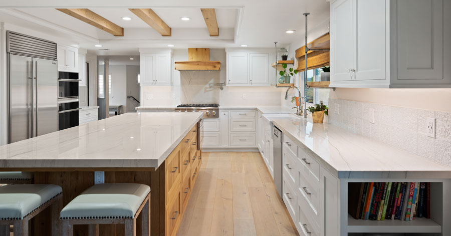 Modern kitchen with white cabinets and stainless steel appliances 