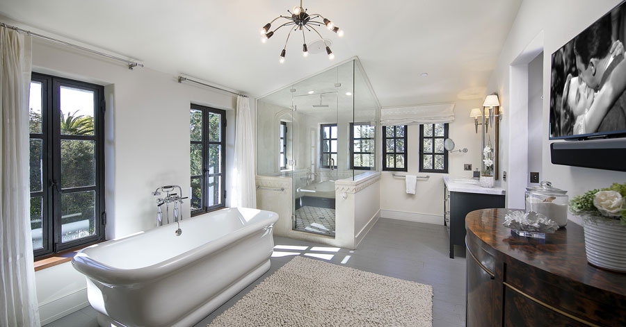 luxury bathrooms featuring painted white with bathtub and glass shower