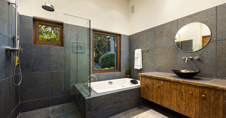 luxury bathroom with stone tile and wooden vanity