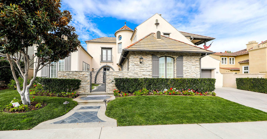 remodeled homes in southern california - exterior with manicured landscaping and gated entrance