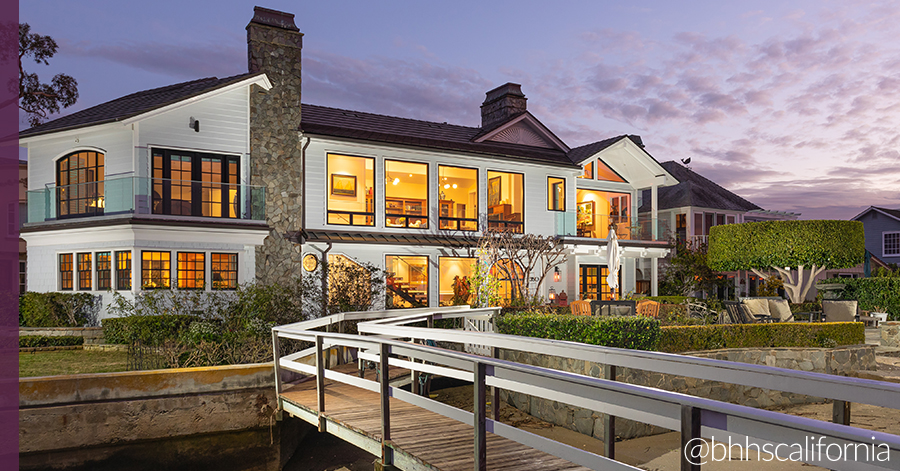 Exterior of Newport Beach bayfront facing harbor home and dock. 