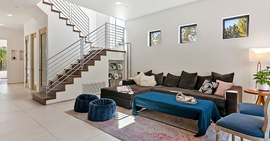 Interior of modern home with tall ceilings bright light and large staircase