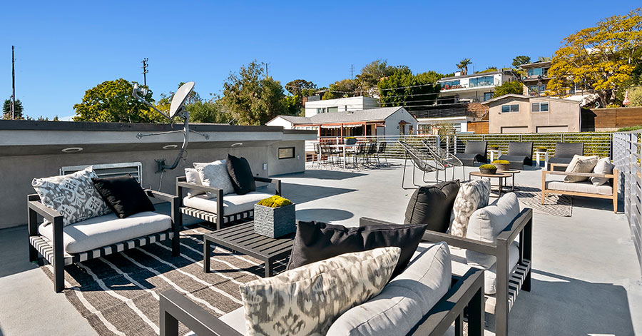 Rooftop deck with several seating areas 