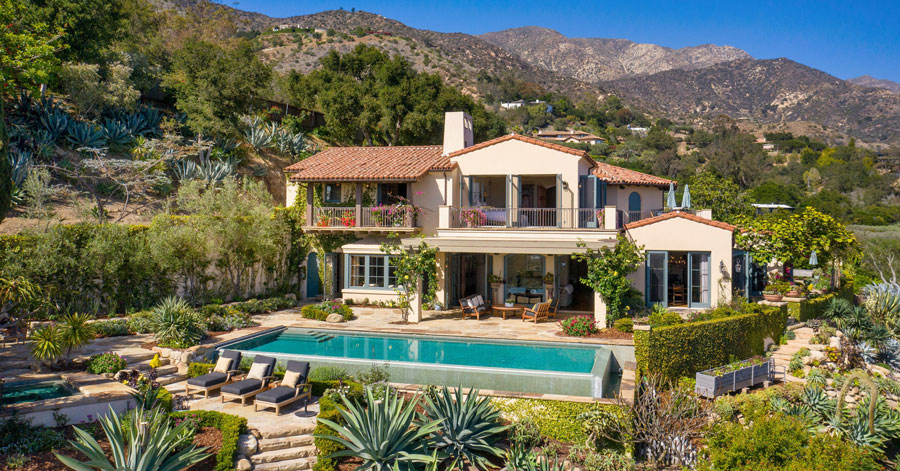 Home pictured in main photo: Backyard of two-story home with pool and gardens 