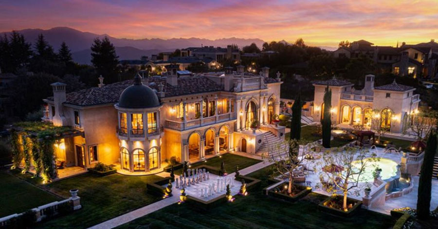 Aerial view of Calabasas estate in the evening with guest house, large pool, and life-size chess game. 