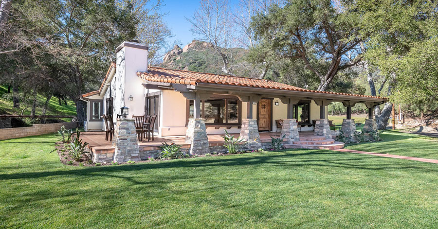 Thousand Oaks home surrounded by a covered patio and lots of lush green grass and trees