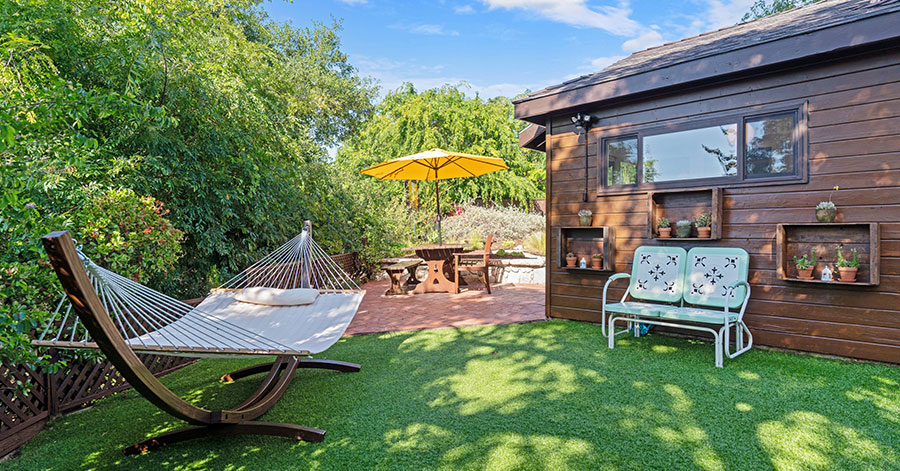 Backyard view of 360 Edwards Place with turf and hammock 