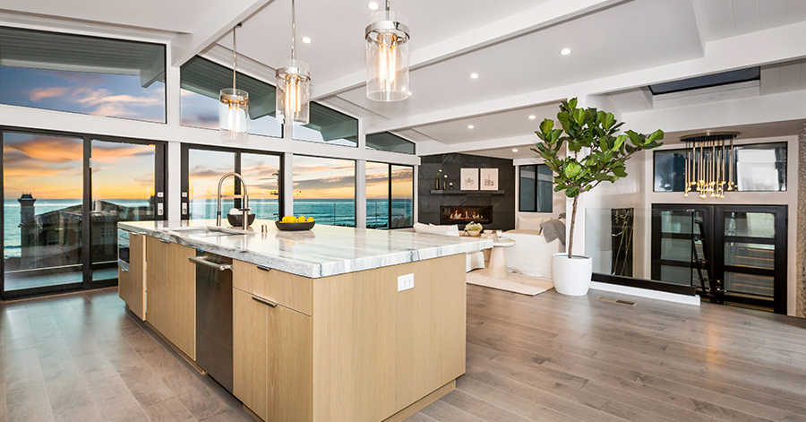 Modern kitchen with wall of glass and ocean view in background 