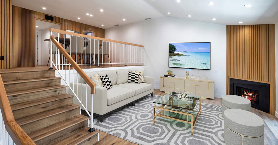 interior of townhouse with modern wood paneled walls and a black fireplace 