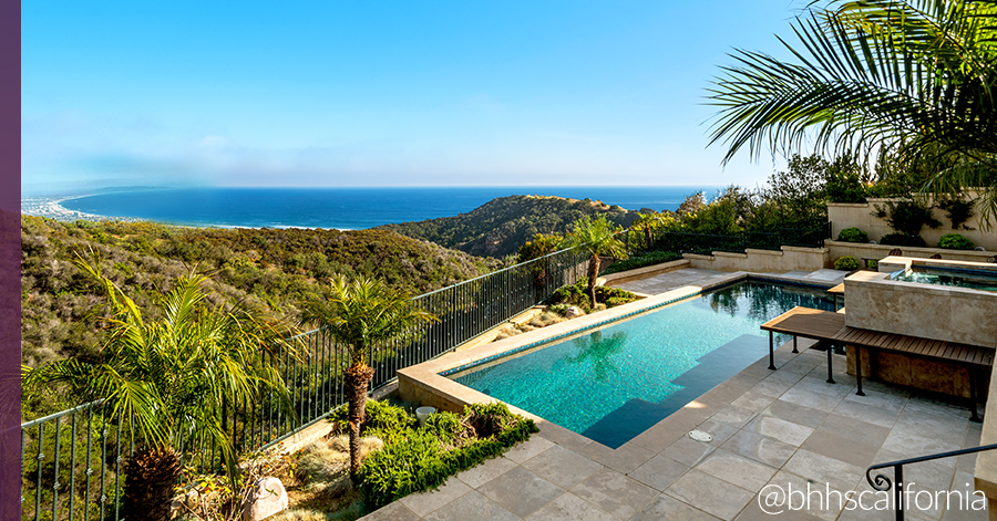 One of five ocean-view homes featured in the blog with a waterfall effect spa that pours into pool. Blue ocean view beyond. 