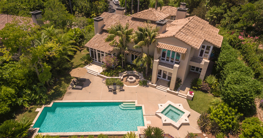 Homes made for outdoor entertaining - aerial view of large home with a pool and separate spa