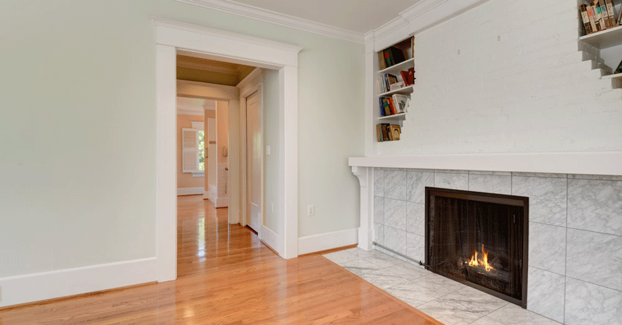 large fireplace with chimney and small built-in bookshelves on either side 