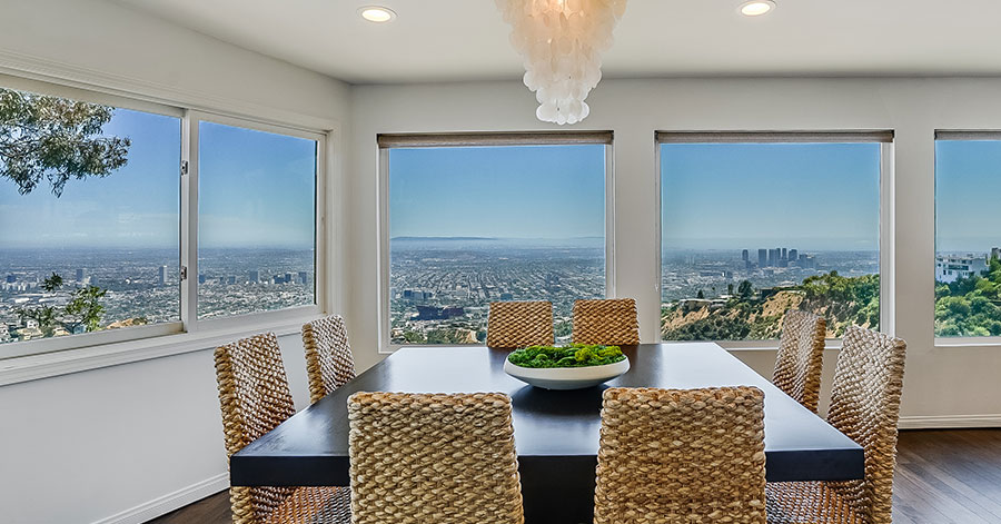 dining table near large windows letting in natural light and los angeles views 